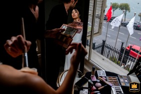 At Six Senses Kocataş Mansions, İstanbul, a wedding photographer captures a reflective moment. The bride is seated before a large mirror, having her makeup applied as she prepares for the ceremony.